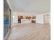 Spacious living area with wood-look tile flooring and modern kitchen in the background at 28958 N 174Th Ln, Surprise, AZ 85387