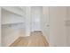 Hallway with hooks and shelves with wood-look ceramic tile flooring at 28958 N 174Th Ln, Surprise, AZ 85387