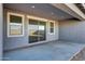 Covered patio with a sliding glass door and two windows that offer backyard views at 28958 N 174Th Ln, Surprise, AZ 85387