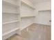 Well-organized walk-in closet with shelving and carpet flooring, providing ample storage space at 28958 N 174Th Ln, Surprise, AZ 85387