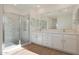 Modern bathroom with double vanity, large mirror and walk-in shower at 28976 N 174Th Ln, Surprise, AZ 85387