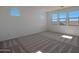 Bright bedroom with carpet flooring and multiple windows at 28976 N 174Th Ln, Surprise, AZ 85387