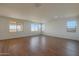 Spacious bedroom with large windows and wood-look tile floors at 28976 N 174Th Ln, Surprise, AZ 85387