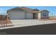 New single-story home with two-car garage and desert landscaping at 28976 N 174Th Ln, Surprise, AZ 85387