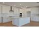 Modern kitchen with white cabinets, island, and stainless steel appliances at 28976 N 174Th Ln, Surprise, AZ 85387