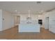 Modern kitchen with white cabinets, island, and stainless steel appliances at 28976 N 174Th Ln, Surprise, AZ 85387