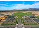 Scenic aerial view featuring the community layout, golf course, and the stunning mountain range backdrop at 17643 W Middlebury St, Surprise, AZ 85388