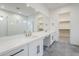 Modern bathroom with a dual sink vanity and walk-in shower with glass door at 17643 W Middlebury St, Surprise, AZ 85388