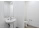 Bathroom featuring a toilet and pedestal sink, providing essential amenities at 17643 W Middlebury St, Surprise, AZ 85388