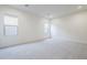 A bright bedroom with white carpet and two windows at 17643 W Middlebury St, Surprise, AZ 85388