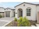 Beautifully landscaped home featuring a stone driveway, a two-car garage, and an arched entryway at 17643 W Middlebury St, Surprise, AZ 85388