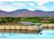 Picturesque golf course view with serene water features and a backdrop of majestic mountains at 17643 W Middlebury St, Surprise, AZ 85388