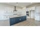 Modern kitchen featuring white cabinets, a large island, and stainless steel appliances at 17643 W Middlebury St, Surprise, AZ 85388