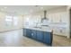 A modern kitchen island with a stainless steel vent at 17643 W Middlebury St, Surprise, AZ 85388