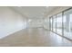 Bright and spacious living room with modern tile flooring and large sliding glass doors at 17643 W Middlebury St, Surprise, AZ 85388