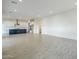 Open concept living area with tile flooring seamlessly flowing into a modern kitchen at 17643 W Middlebury St, Surprise, AZ 85388