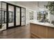 Welcoming lobby featuring dark-trimmed glass doors, wood floors, built-in shelving, and stylish lighting fixtures at 17643 W Middlebury St, Surprise, AZ 85388