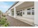 Stylish covered patio featuring a stucco ceiling and pillars, leading to a backyard area with desert landscaping at 17643 W Middlebury St, Surprise, AZ 85388