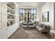 Bright sitting area with white built-in shelves and a large window view of palm trees at 17643 W Middlebury St, Surprise, AZ 85388