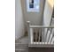 Modern white staircase with gray carpeting and a window above at 2593 E Bluff Spring Ave, Apache Junction, AZ 85119