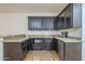 This wet bar has granite countertops, dark cabinets, a stainless steel mini-fridge and recessed lighting at 3414 E Virgil Dr, Gilbert, AZ 85298