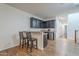 This wet bar has granite countertops, dark cabinets, stainless steel mini-fridge and room for bar stools at 3414 E Virgil Dr, Gilbert, AZ 85298