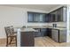 This wet bar features granite countertops, dark cabinets, a stainless steel mini-fridge and bar seating at 3414 E Virgil Dr, Gilbert, AZ 85298