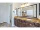 Bathroom featuring double vanity, granite countertop, large mirror, and access to the toilet room at 3414 E Virgil Dr, Gilbert, AZ 85298