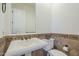 Elegant powder room featuring decorative tile accents, pedestal sink, and framed mirror at 3414 E Virgil Dr, Gilbert, AZ 85298