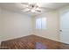 This bedroom has dark wood floors, white walls and a ceiling fan at 3414 E Virgil Dr, Gilbert, AZ 85298