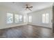 Spacious bedroom with many windows, wood-look floors, and a ceiling fan at 3414 E Virgil Dr, Gilbert, AZ 85298