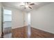 This bedroom has dark wood floors, a ceiling fan and a closet with a light at 3414 E Virgil Dr, Gilbert, AZ 85298