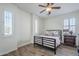 Bedroom featuring wood floors, two windows with shutters and a ceiling fan at 3414 E Virgil Dr, Gilbert, AZ 85298