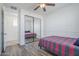 Comfortable bedroom featuring wood floors and a mirrored closet at 3414 E Virgil Dr, Gilbert, AZ 85298