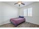 Cozy bedroom with wood floors, a ceiling fan, and a window with shutters at 3414 E Virgil Dr, Gilbert, AZ 85298