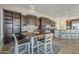 Bright dining area with dark wood cabinets, a rustic table set, and an open layout connecting to the gourmet kitchen at 3414 E Virgil Dr, Gilbert, AZ 85298