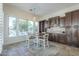 Cozy dining area with a view of the pool, complemented by custom cabinetry and natural light through large windows at 3414 E Virgil Dr, Gilbert, AZ 85298