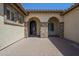 Arched entryway and doorway with stone columns and brick-paved front entrance at 3414 E Virgil Dr, Gilbert, AZ 85298