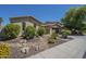 Single-story home with desert landscaping with yellow flowering shrubs and an attached two-car garage at 3414 E Virgil Dr, Gilbert, AZ 85298