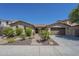 Charming single-story home with desert landscaping, brick walkway, and attached two-car garage at 3414 E Virgil Dr, Gilbert, AZ 85298