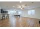 An open game room features wood floors, bar seating, staircase and recessed lighting throughout at 3414 E Virgil Dr, Gilbert, AZ 85298