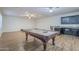 This game room features a pool table, wood floors, and a bar area with dark cabinets and granite countertops at 3414 E Virgil Dr, Gilbert, AZ 85298