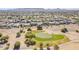 Scenic aerial view of a lush green golf course featuring well-manicured lawns, sand traps, and mature trees at 3414 E Virgil Dr, Gilbert, AZ 85298