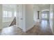 Bright hallway featuring tile flooring, white walls, and decorative arches leading to other rooms at 3414 E Virgil Dr, Gilbert, AZ 85298