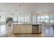 Open concept kitchen featuring a large island, stainless steel appliances, and seamless transition to the living and dining areas at 3414 E Virgil Dr, Gilbert, AZ 85298