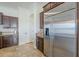 Modern kitchen with stainless steel refrigerator, sleek dark wood cabinets, and granite countertops, offering ample storage at 3414 E Virgil Dr, Gilbert, AZ 85298
