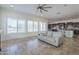 Open living room with tile floors, a ceiling fan, and plantation shutters at 3414 E Virgil Dr, Gilbert, AZ 85298