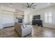 Comfortable living room has tile floors, custom shelves, and a fireplace at 3414 E Virgil Dr, Gilbert, AZ 85298