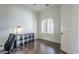 Well-lit office features wood floors, built-in shelving, and a window with shutters at 3414 E Virgil Dr, Gilbert, AZ 85298