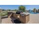 An outdoor kitchen with a built-in grill area perfect for entertaining by the pool at 3414 E Virgil Dr, Gilbert, AZ 85298